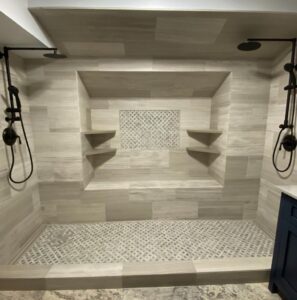 Completed Lion Heart walk-in shower with stone tile and dual rain heads