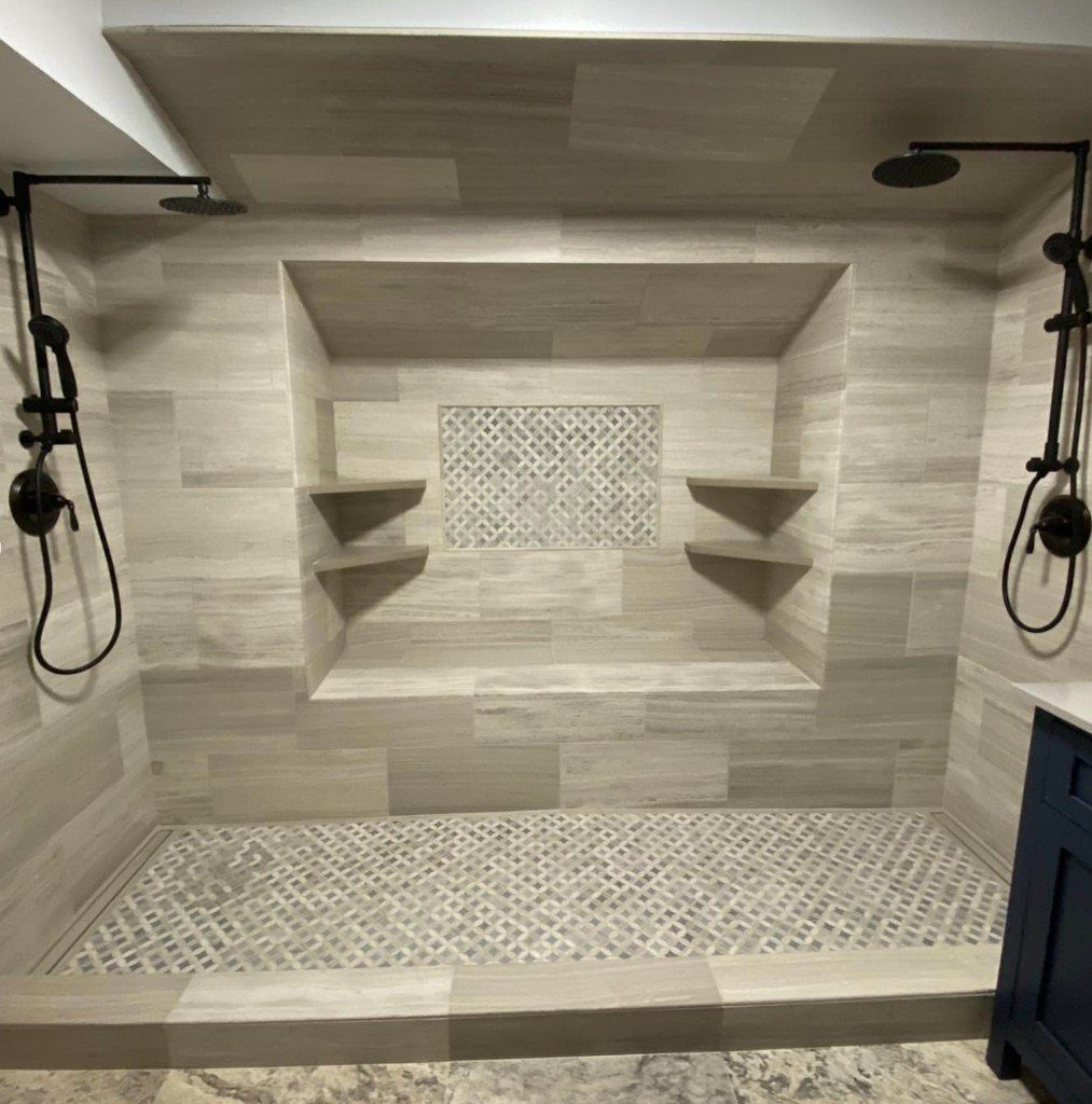 Completed Lion Heart walk-in shower with stone tile and dual rain heads