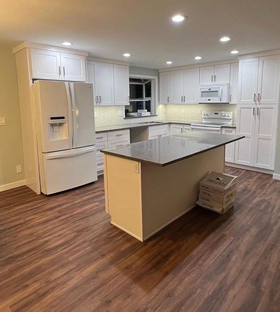 Completed Lion Heart white kitchen with a dark-top island