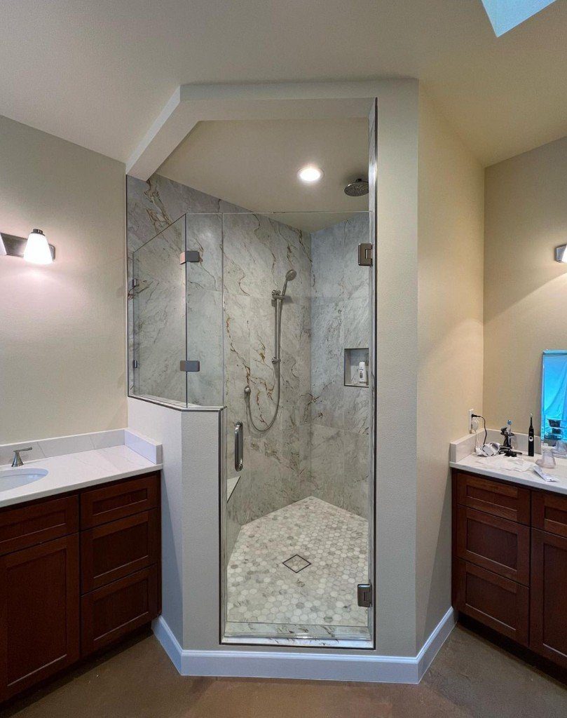 Completed Lion Heart corner glass shower with stone tile