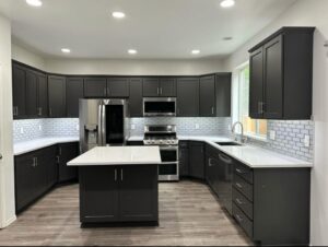 Completed Lion Heart kitchen with dark cabinetry and a white island