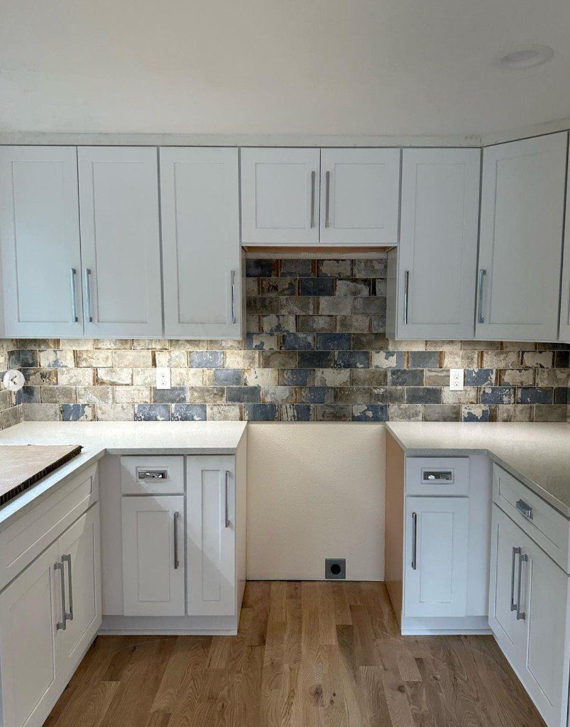 Completed Lion Heart white kitchen with a brick backsplash
