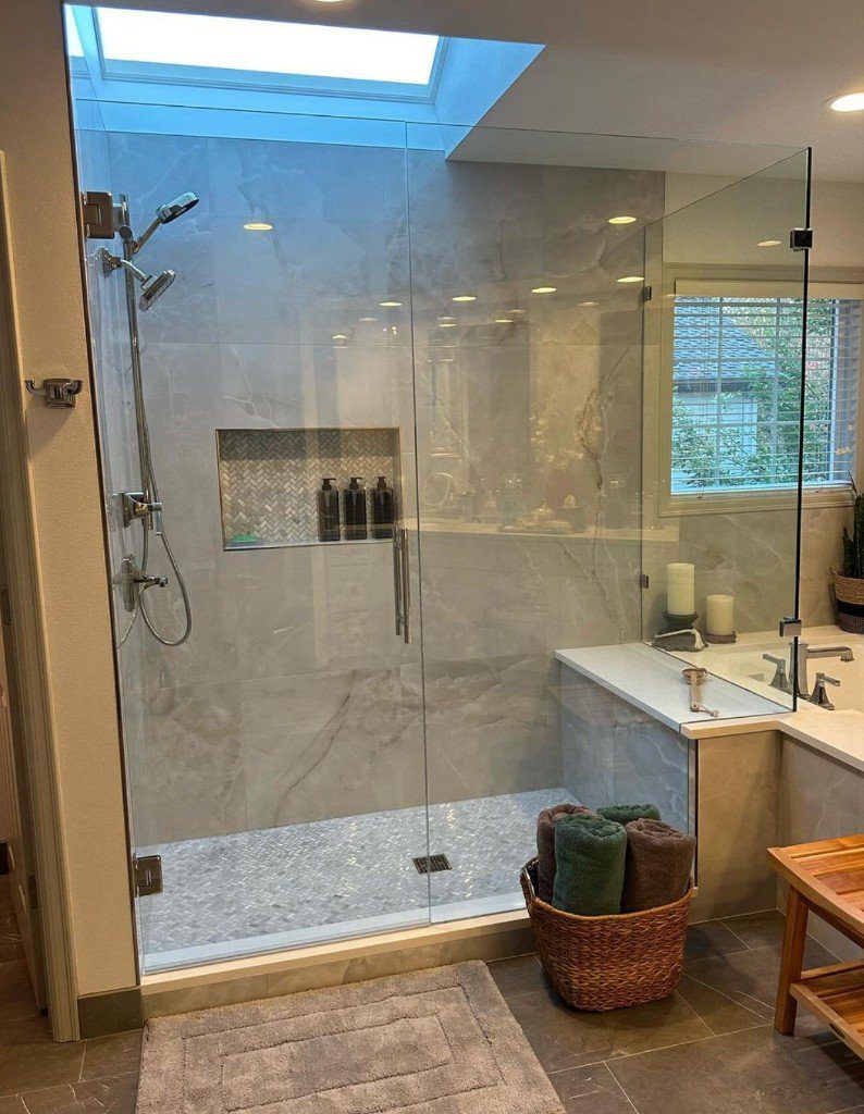 Completed Lion Heart bathroom with a glass shower, tub, and skylight