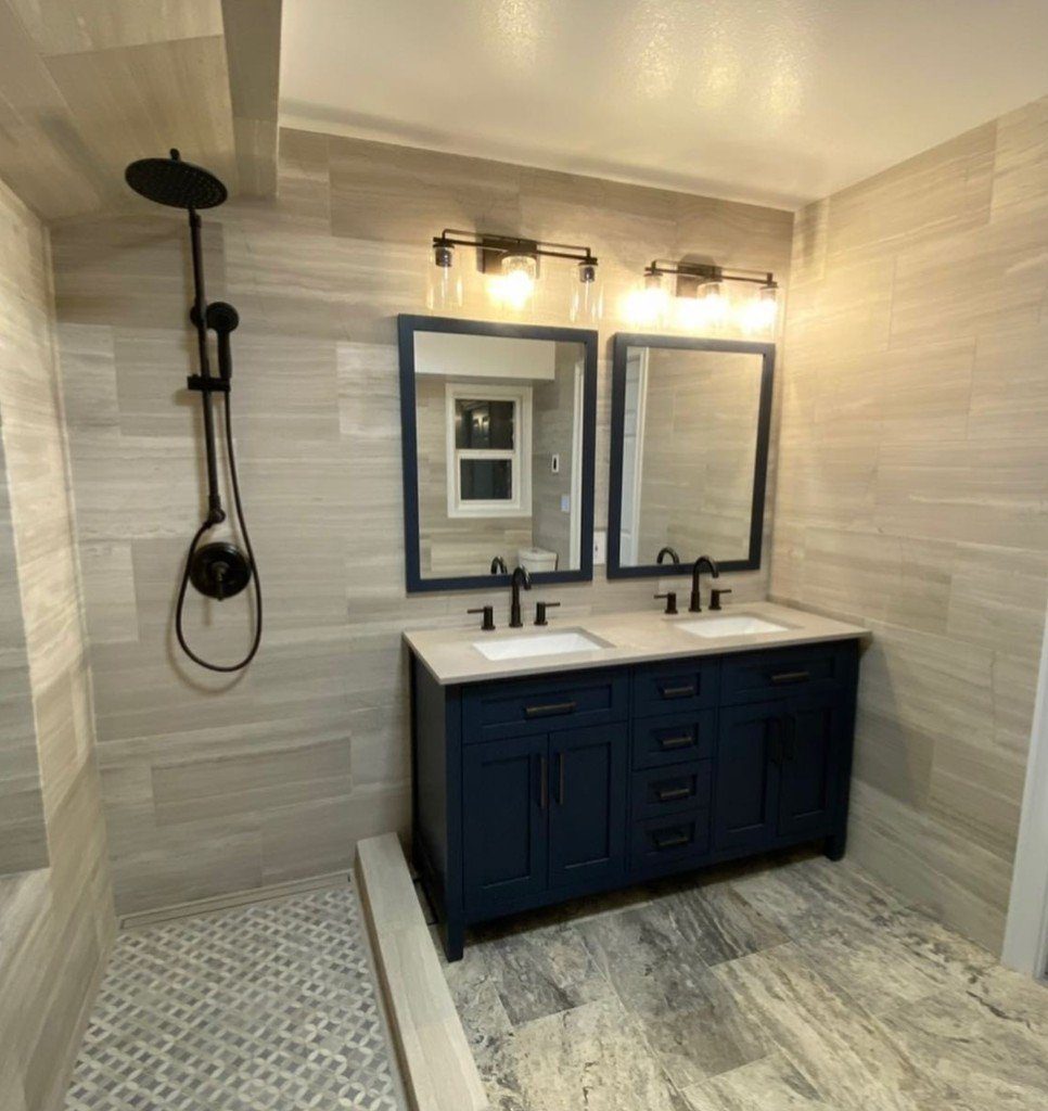 Completed Lion Heart bathroom with a navy double vanity and stone tile