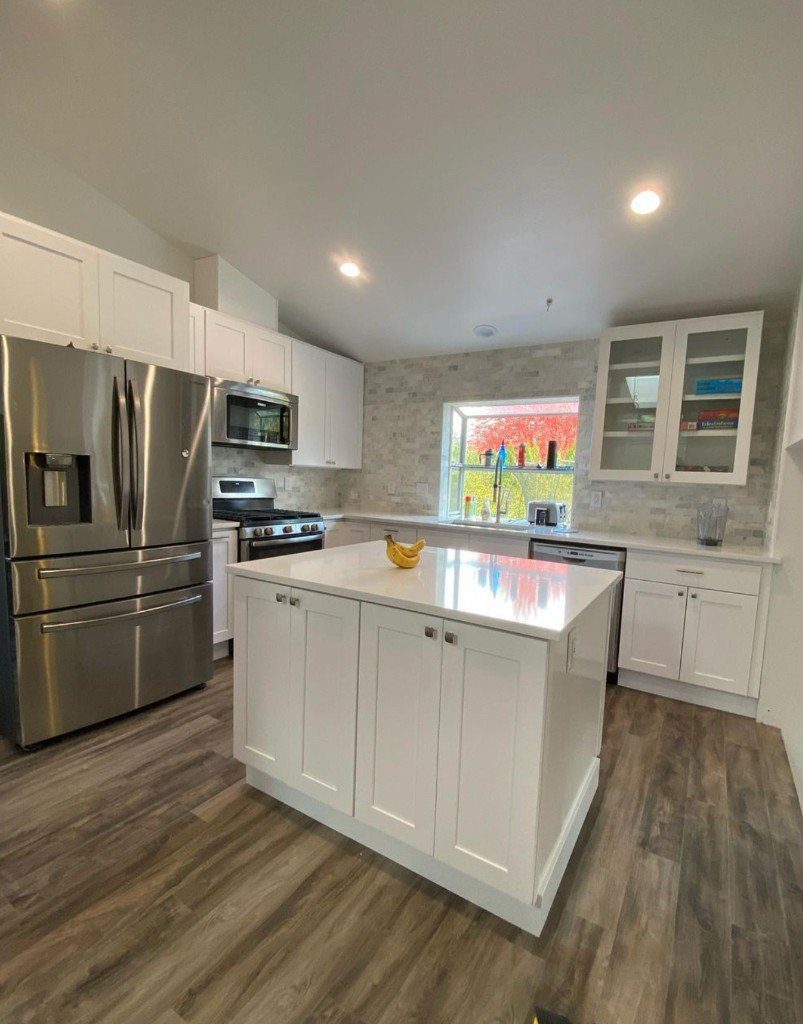 Completed Lion Heart white kitchen with a blue accent wall and island