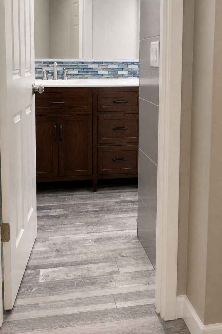 Completed Lion Heart bathroom vanity with wood cabinets and new flooring.