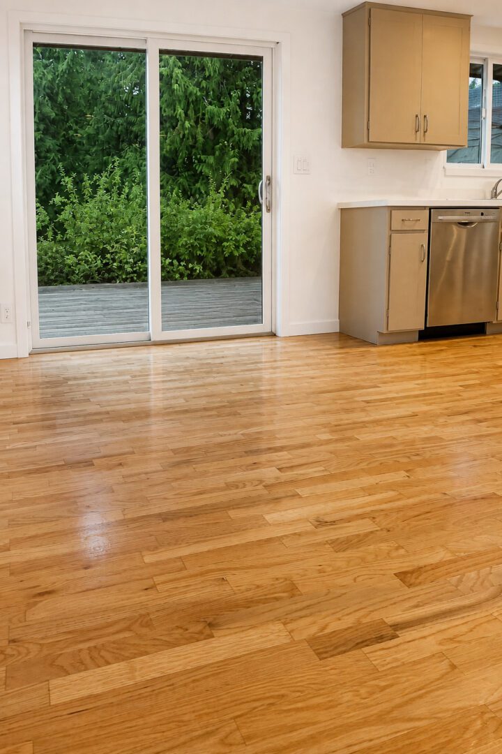 Completed Lion Heart hardwood floor toward a slider and deck.
